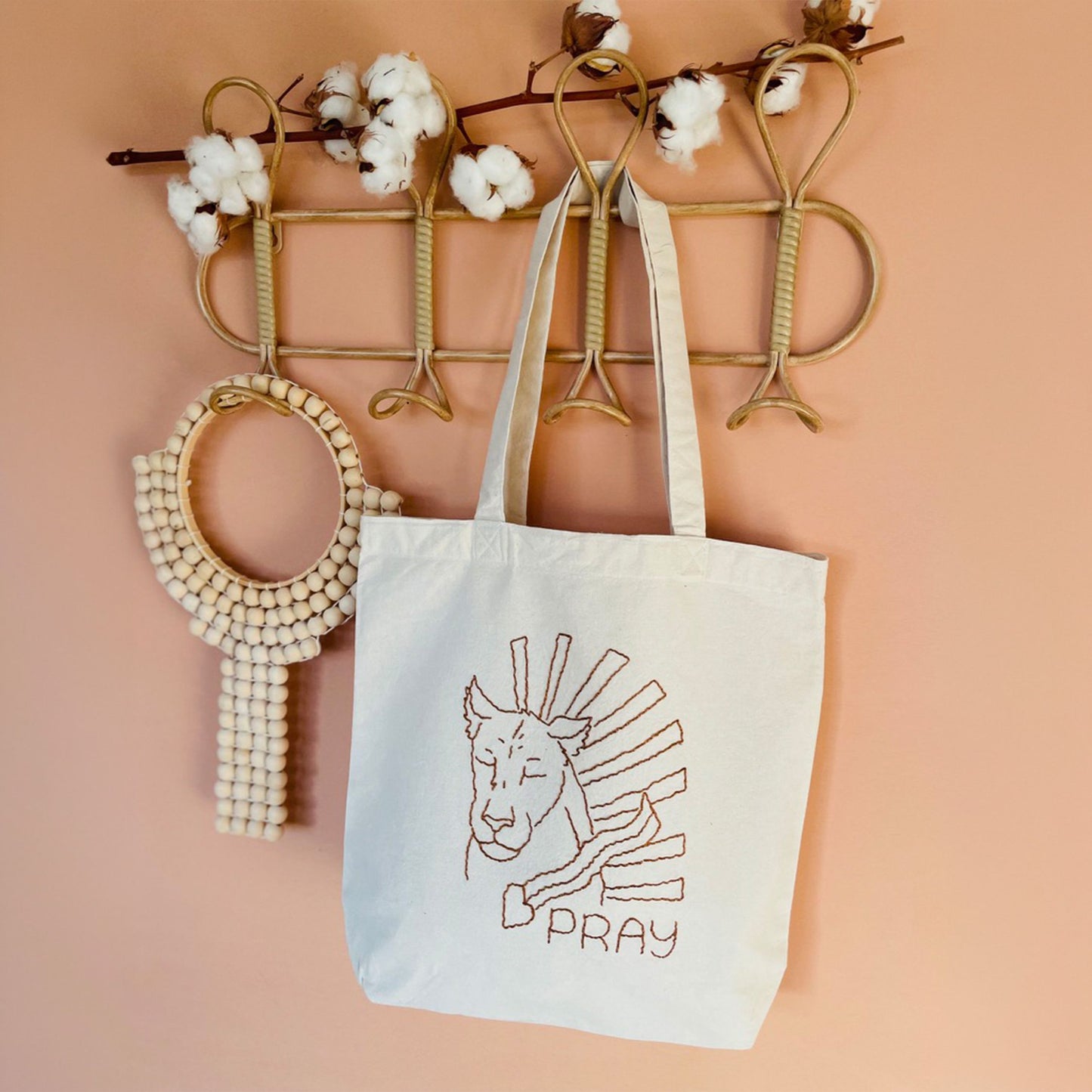 Lioness of Prayer embroidery design stitched on a tote bag, inspired by 1 Thessalonians 5:17 and the message of prayer.