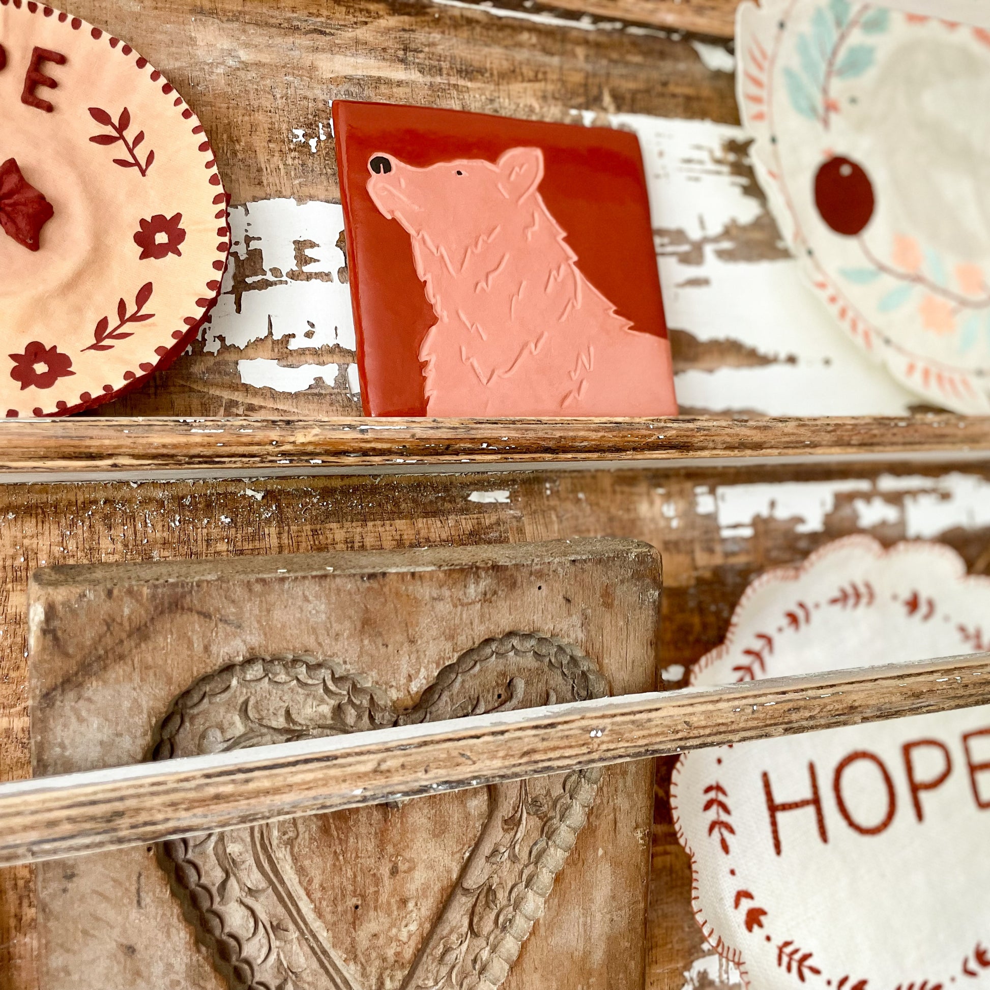 Look Up Bear clay tile displayed on a rustic shelf with handmade faith-inspired decor, inspired by Psalm 121.